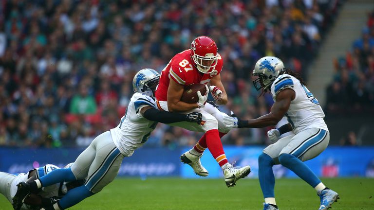 Travis Kelce #87 of the Kansas City Chiefs is tackled by Glover Quin #27 of the Detroit Lions defence during the NFL match 