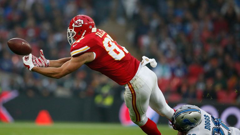 Travis Kelce #87 of Kansas City Chiefs drops a pass as he is tackled by Quandre Diggs