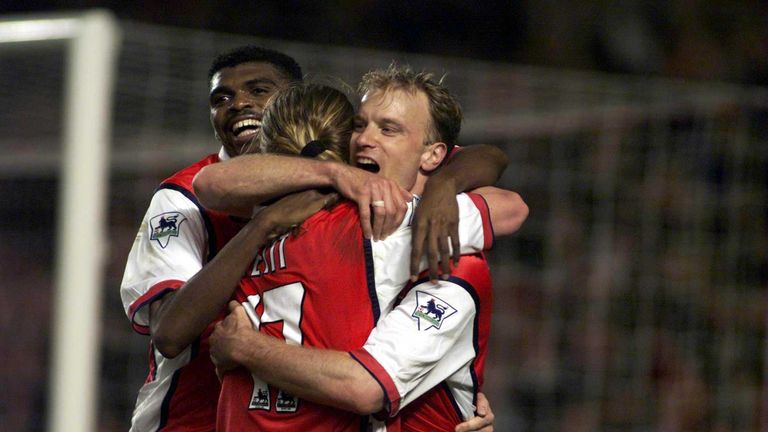 Dennis Bergkamp (R) and Kanu (L) of Arsenal celebrate with winning goal scorer Petit against West Ham in May 2000