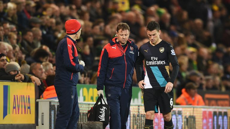 Arsenal's Laurent Koscielny leaves the pitch after suffering an injury