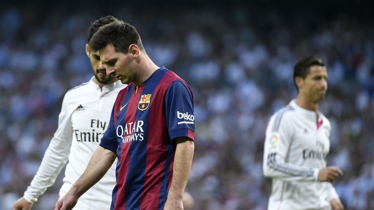 Barcelona's Argentinian forward Lionel Messi (2nd L) looks down next Real Madrid's midfielder Isco (L) and Real Madrid's Portuguese forward Cristiano Ronal