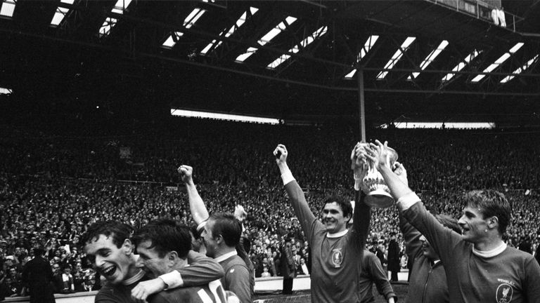Captain of Liverpool FC, Ron Yeats (centre) holds the FA Cup aloft in 1965