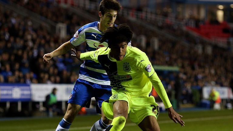 Philip Billing of Huddersfield holds off Reading's Lucas Piazon