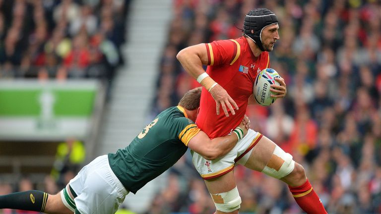 Wales' lock Luke Charteris (R) is tackled  by South Africa's number 8 Duane Vermeulen