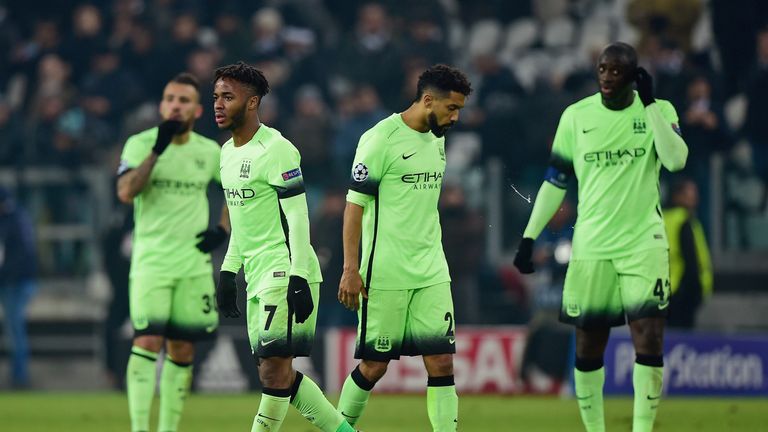 Dejected Manchester City players look on