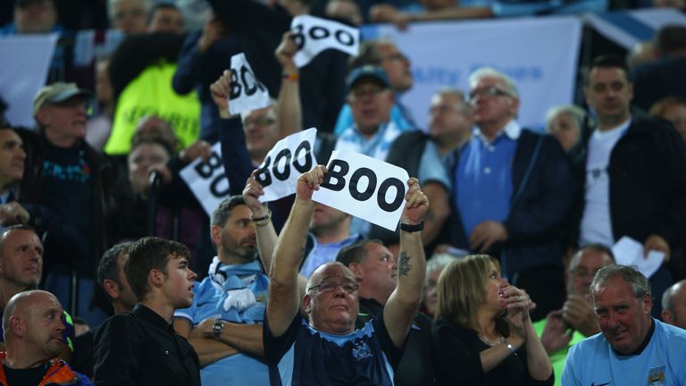 Manchester City fans hold 'Boo' signs prior to the UEFA Champions League Group D match between Sevilla and Manchester City