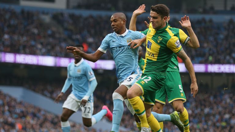 Fernandinho of Manchester City and Robbie Brady of Norwich City compete for the ball