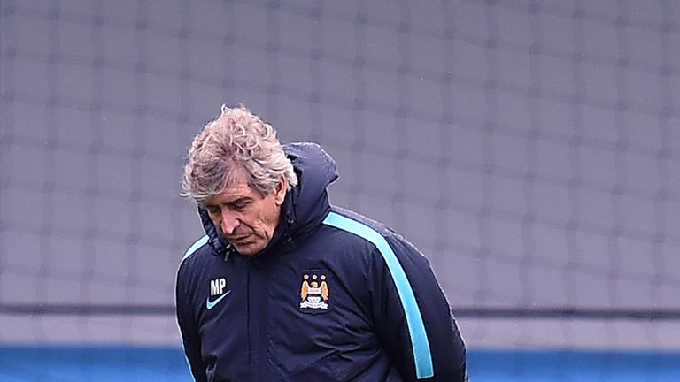 Manuel Pellegrini looks on as his team trains ahead of the Champions League clash with Juventus