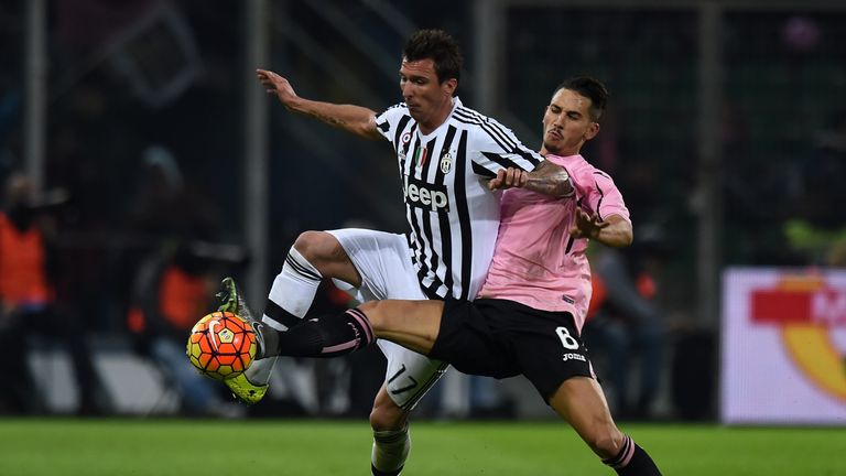Mario Mandzukic (left) of Juventus is challenged by Edoardo Goldaniga of Palermo