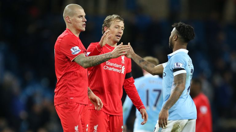 Manchester City's Raheem Sterling is consolled by Liverpool's Martin Skrtel and Liverpool's Lucas Leiva