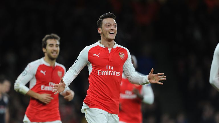 Mesut Ozil celebrates scoring Arsenal's first goal during the UEFA Champions League match against Dinamo Zagreb