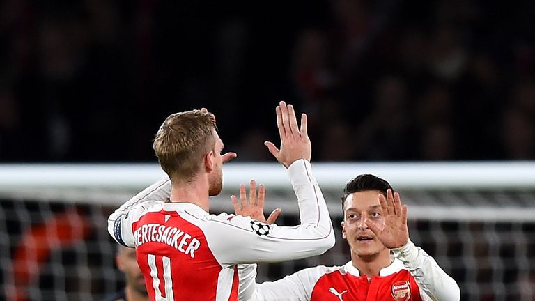 Mesut Ozil of Arsenal (r) celebrates scoring his side's first goal with Per Mertesacker during the UEFA Champions League match against Dinamo Zagreb