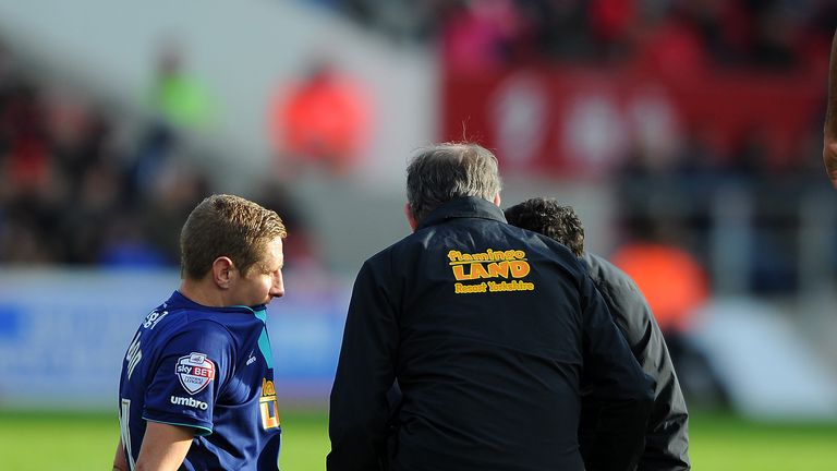 Michael Dawson of Hull City(C) receives treatment and is taken off injured at Britsol City
