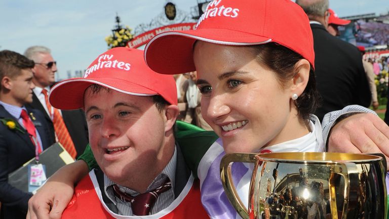 MELBOURNE, AUSTRALIA - NOVEMBER 03:  Michelle Payne hugs brother Stephen Payne (strapper) and poses with the trophy after riding Prince of Penzance to win 