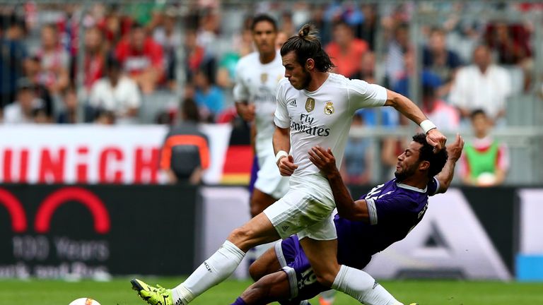 Gareth Bale (L) of Real Madrid is challenged by Mousa Dembele of Tottenham Hotspur during the Audi Cup 2015 match between Real Madrid and Tottenham