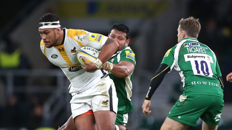   Nathan Hughes of Wasps is tackled by Ofisa Treviranus during the Aviva Premiership match against London Irish 