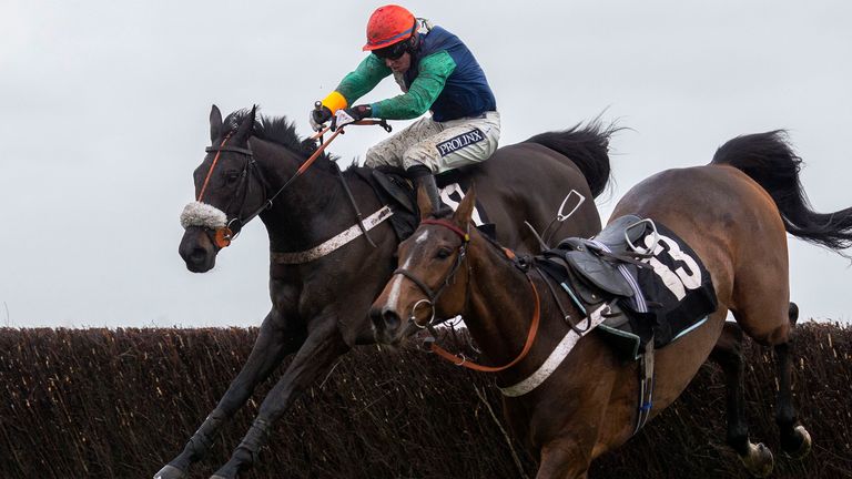 Aloomomo, ridden by Gavin Sheehan, avoids a loose horse at the last fence en route to winning the Sir Peter O' Sullevan Memorial Handicap Chase at Newbury