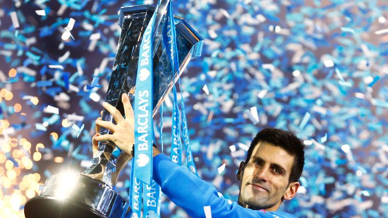 Novak Djokovic lifts the trophy following his victory during the men's singles final against Roger Federer