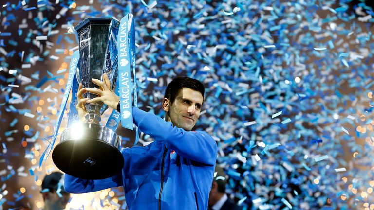 LONDON, ENGLAND - NOVEMBER 22:  Novak Djokovic of Serbia lifts the trophy following his victory during the men's singles final against Roger Federer of Swi