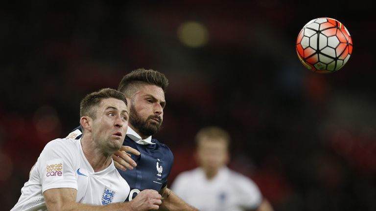 France's forward Olivier Giroud (R) vies against England's defender Gary Cahill