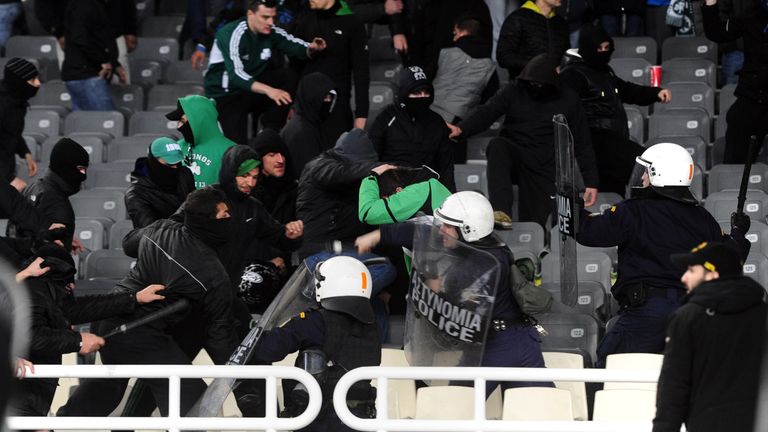 Greek riot police clash with Panathinaikos supporters during a Greek Super League football game against Olympiakos in Athens on March 18, 2012. AFP PHOTO /