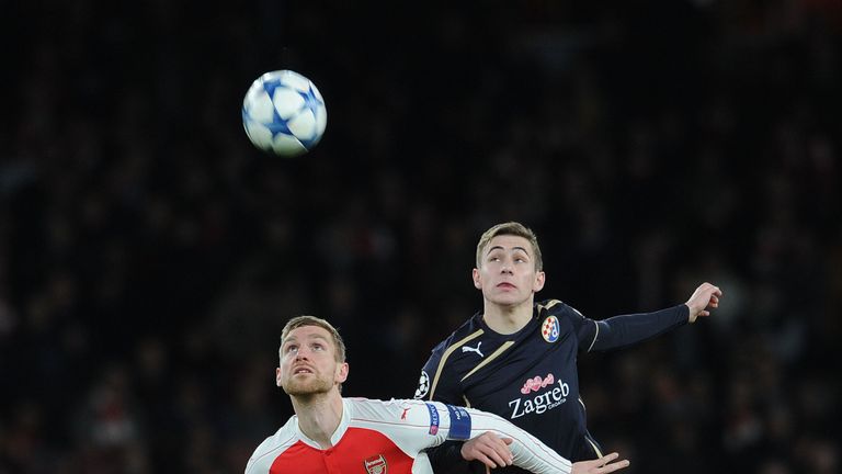 Per Mertesacker of Arsenal heads the ball away from Marko Rog of Zagreb during the match in the UEFA Champions League on November 24 2015