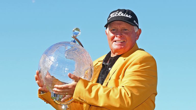 Peter Senior poses in his golden jacket with the Australian Masters trophy