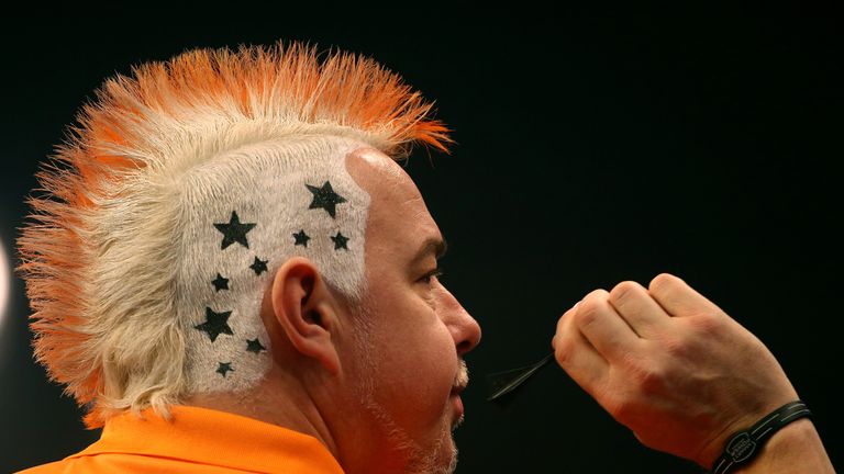 Peter Wright of Scotland shows off his hair style during his third round match against Andy Hamilton of England during the W