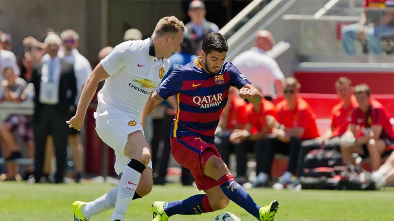 SANTA CLARA, CA - JULY 25:  Luis Suarez #9 of FC Barcelona weaves his way past Phil Jones #4 of Manchester United FC in the first half during the Internati