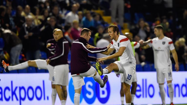 Harry Kane and Wayne Rooney of England warm up