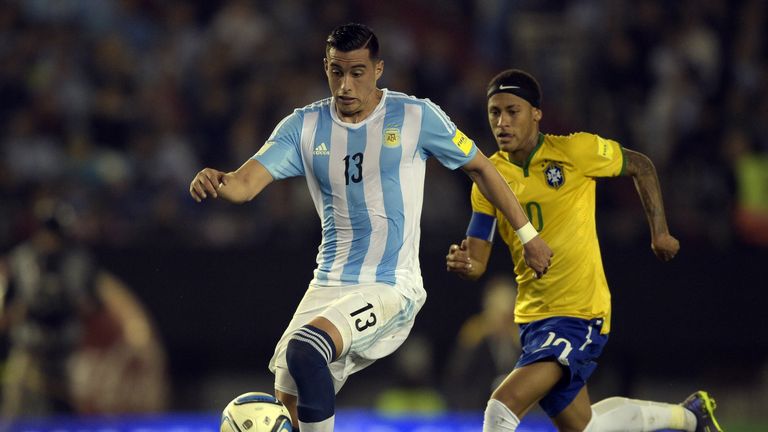 Argentina's Ramiro Funes (L) controls the ball next to Brazil's Neymar 