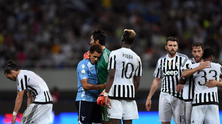 Morrison embraces Juventus goalkeeper Gianluigi Buffon after Lazio's defeat in the Italian Super Cup final