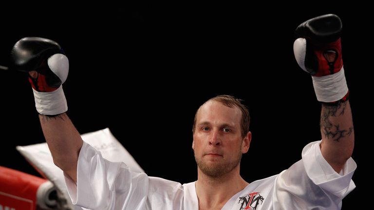 Michael Sprott (L) of Great Britain and Robert Helenius of Finland exchange punches during the Heavyweight fight at Getec Aren