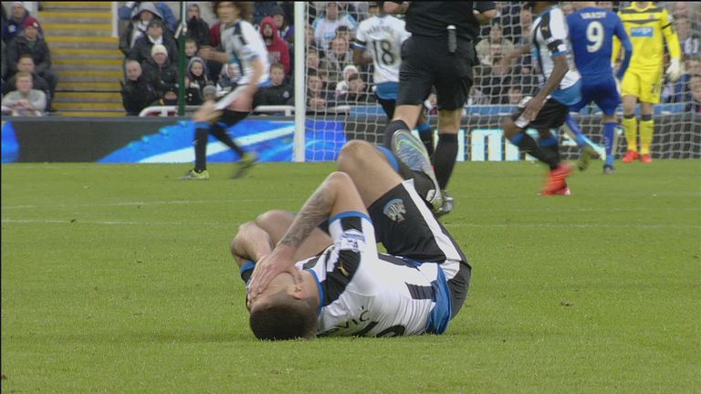 Aleksandar Mitrovic holds his face after getting shoved in the throat by Robert Huth.