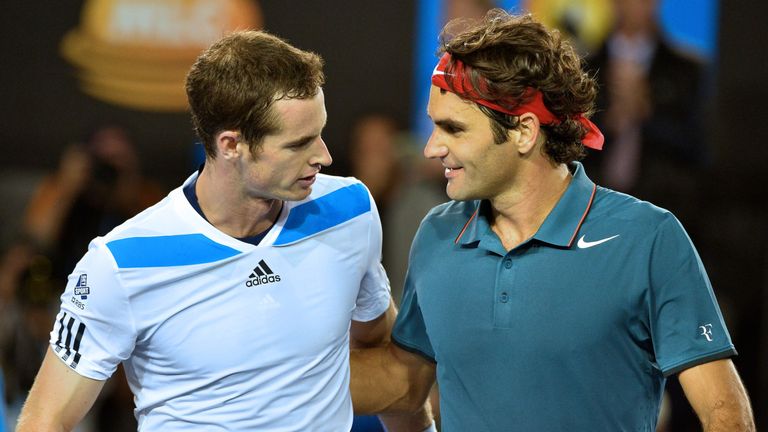 Switzerland's Roger Federer (R) embraces as he celebrates after victory in his men's singles match against Britain's Andy Murray (L) on day ten of the 2014