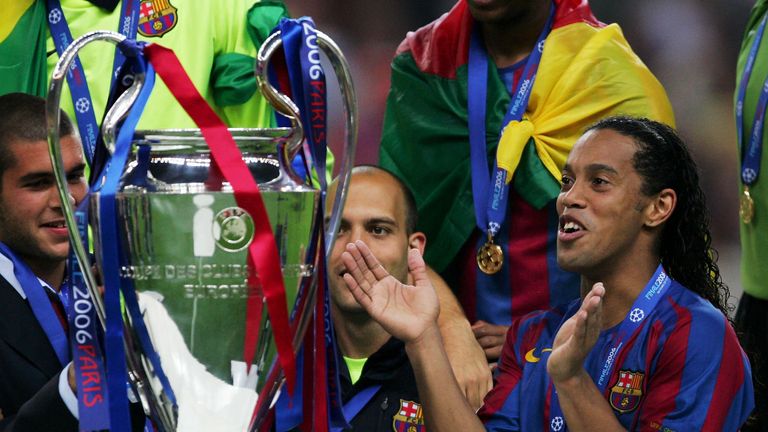 PARIS - MAY 17:  Ronaldinho (C) of Barcelona waits to hold the trophy alongside celebrating team mates after they win the UEFA Champions League Final betwe