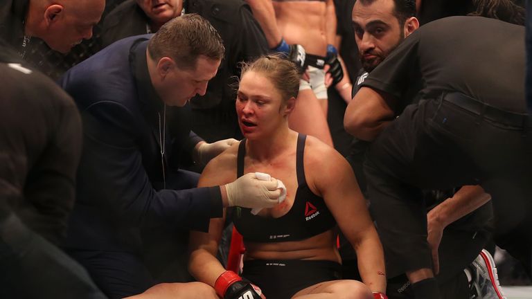 Ronda Rousey of the United States receives medical treatment after being defeated by Holly Holm