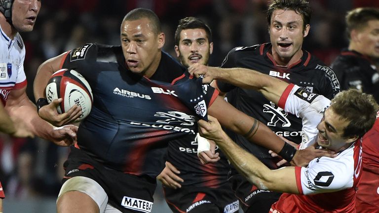 Toulouse centre Gael Fickou is tackled by Grenoble scrum-half James Hart