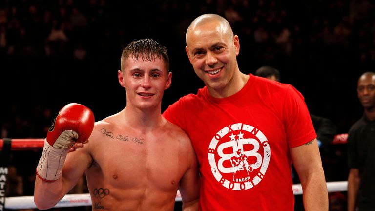 Ryan Burnett (left) celebrates his victory over Jason Booth with trainer Adam Booth during the vacant BBBofC British bantamweight title at Manchester Arena