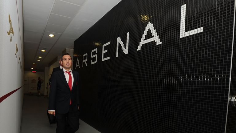 Santi Cazorla arrives in the Arsenal changing room before the Barclays Premier League match between Arsenal and Tottenham Hotspur at Emirates Stadium