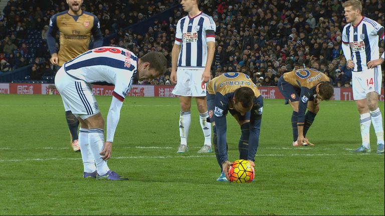 Craig Gardner tries to delay the taking of Santi Cazorla's penalty.  