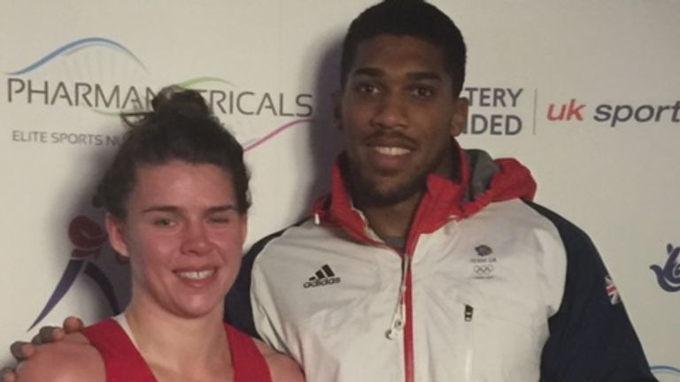 Savannah Marshall receives her prize from pro fighter Anthony Joshua 