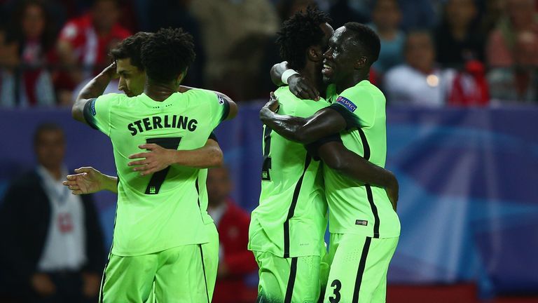 Man City players celebrate after beating Sevilla