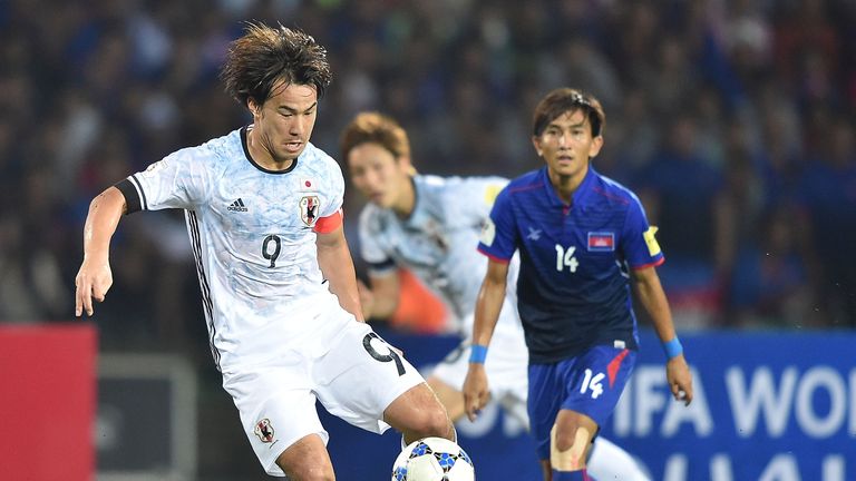 Shinji Okazaki holds the ball during the 2018 FIFA World Cup Qualifier match between Cambodia and Japan 