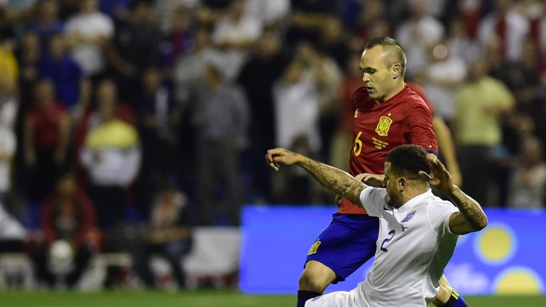 Kyle Walker slides in on Andres Iniesta