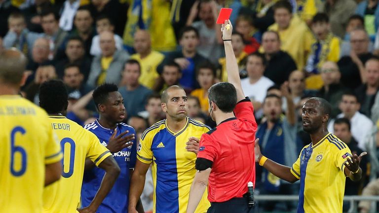 Tal Ben Haim (C) receives a red card during the UEFA champions league football match between Maccabi Tel Aviv and Chelsea