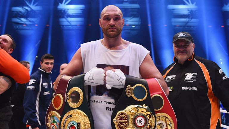 Tyson Fury celebrates with his belts after defeating Wladimir Klitschko