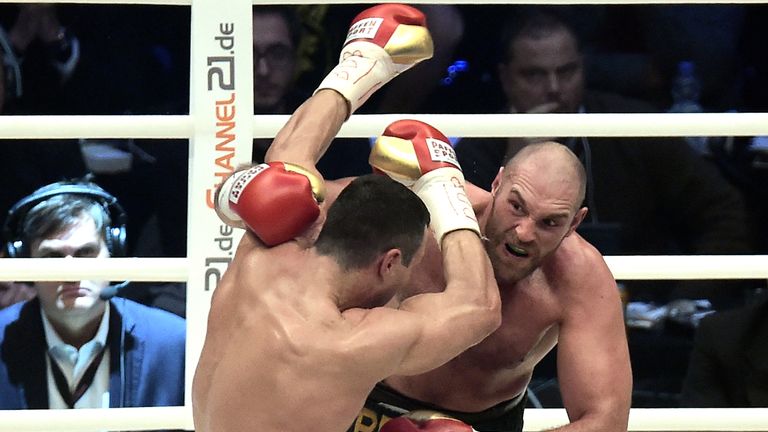 Wladimir Klitschko (L) fights Tyson Fury at Esprit-Arena on November 28