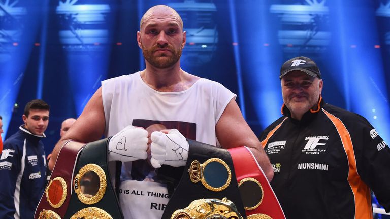 DUESSELDORF, GERMANY - NOVEMBER 28:  Tyson Fury celebrates with belts as he defeats Wladimir Klitschko to 