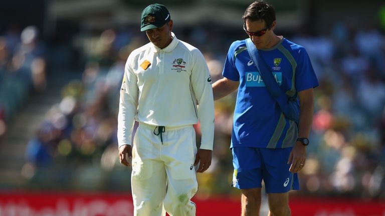 PERTH, AUSTRALIA - NOVEMBER 14:  Usman Khawaja of Australia leaves the ground with an injury during day two of the second Test match between Australia and 